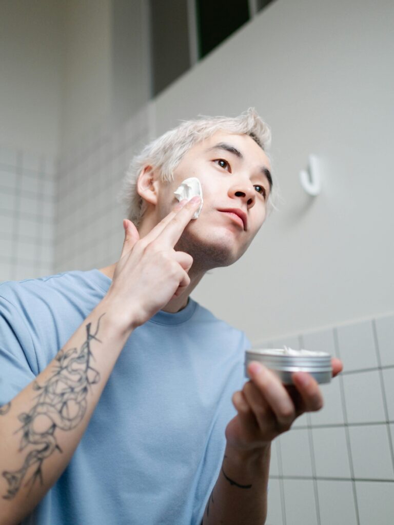 Man applying moisturizer on acne-prone skin
